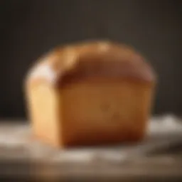 Baked loaf of white bread showcasing a golden crust and soft interior