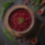 A bowl of vibrant cranberry sauce garnished with fresh herbs