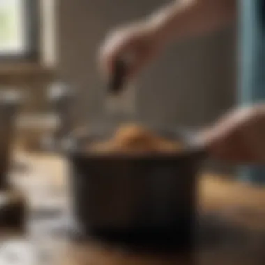 A person using a scrub brush to clean a burnt pot