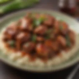 A close-up view of bourbon chicken on a plate garnished with green onions