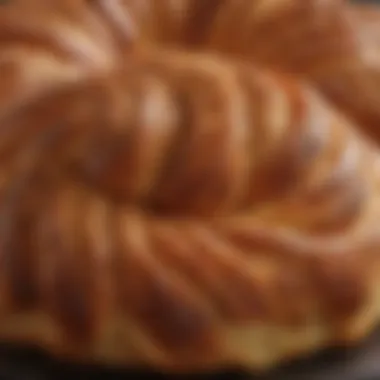 Close-up of the flaky, golden crust of cinnamon babka, highlighting its texture and sheen.