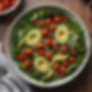 A bowl of fresh leafy greens mixed with cherry tomatoes and avocado