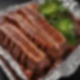 Close-up of succulent ribs wrapped in foil, ready for grilling.