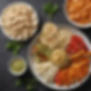 Artful Snack Plate An assortment of bite-sized snacks including hummus, pita, and fresh vegetable sticks arranged artistically.