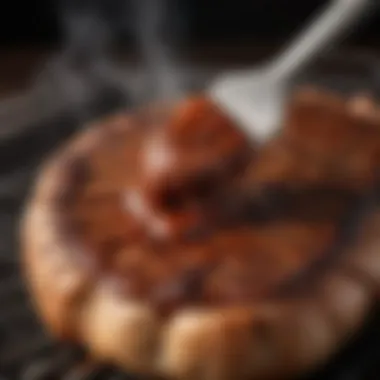 A close-up of a smoky barbecue sauce being brushed onto grilled meat