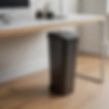 Ultra slim tall trash can tucked beside a desk in an office